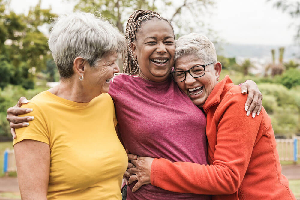 Happy multiracial senior women having fun together outdoor