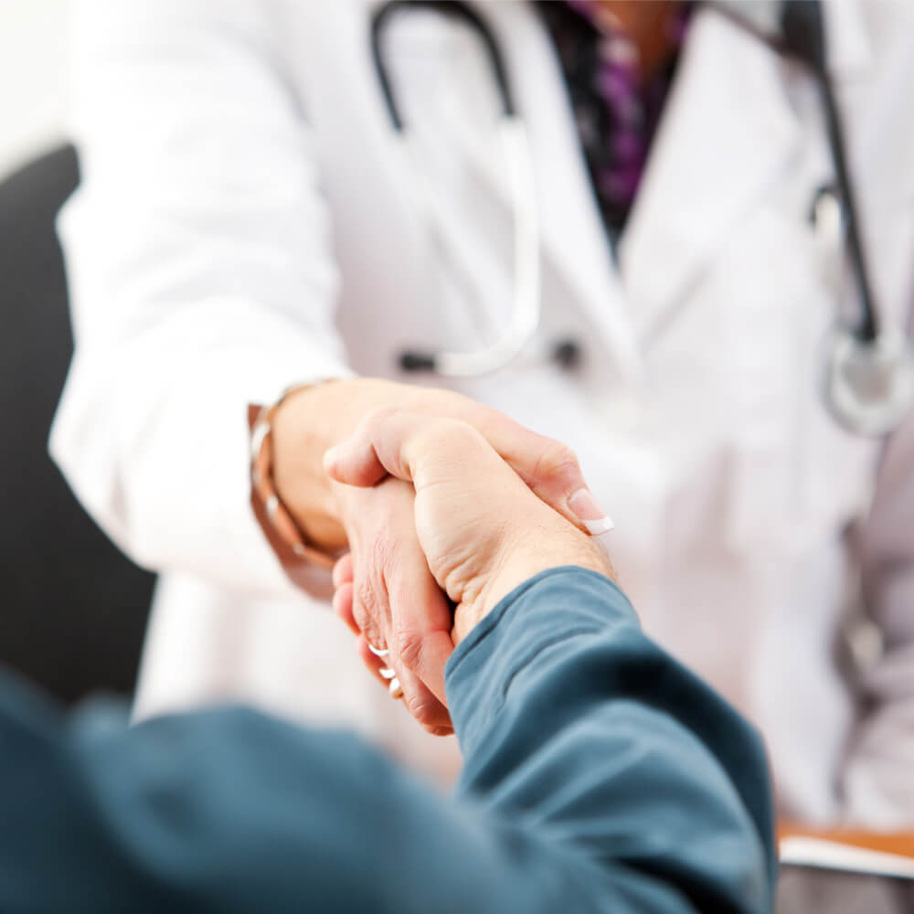 Doctor: Anonymous Patient And Female Doctor Shaking Hands